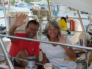 Guy and Louise waving goodbye from their boat in Hope Town