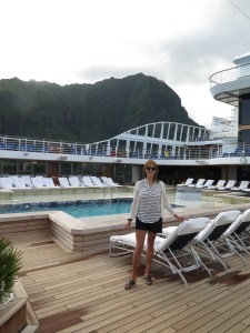 Lee by the pool on the ship with the hills of Tahiti behind