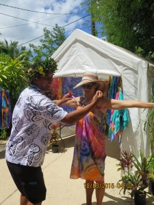 A local uses Lee to demonstrate how to tie the lovely wraps made while we watched